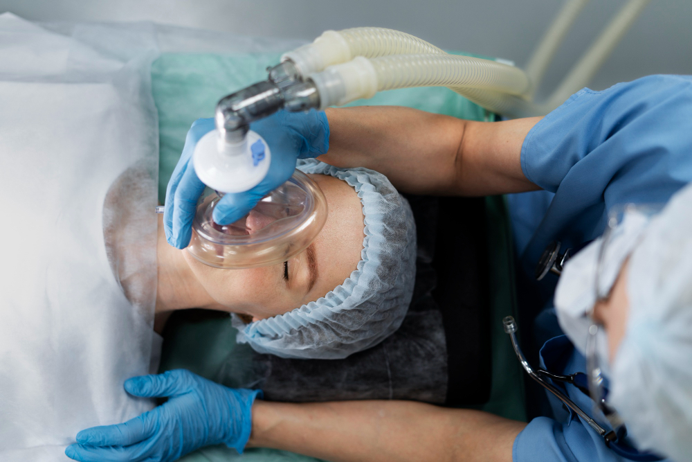 A nurse administering an anesthesia/oxygen mask on a patient awaiting dental surgery